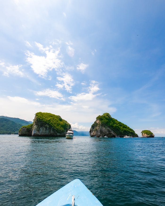 Picturesque view of rough rocky formations in blue sea water under clear sky